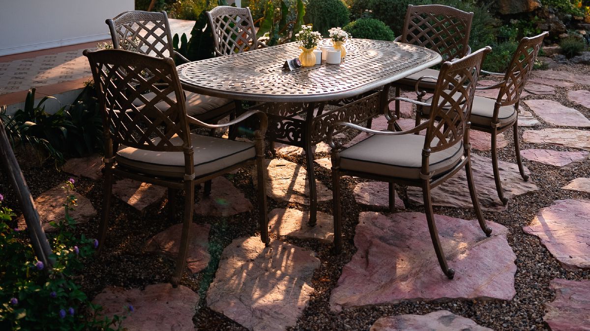 A garden terrace at WIROON with a table set for guests among trees and planting